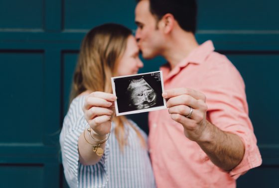 A couple holding a picture of an ultrasound