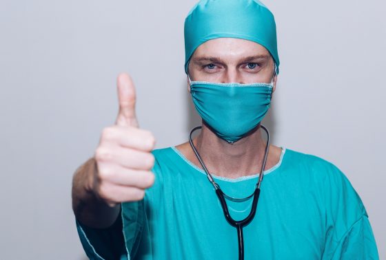 A medical professional giving a thumbs up